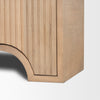 Close-up shot focusing on the unique arched cutout base design and the precision of the vertical fluted wood panels