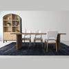Lifestyle view of the cabinet positioned in a hallway next to a wooden staircase for functional entryway storage