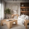 Lifestyle view featuring the Archimedes cocktail table styled in a contemporary living room alongside its matching arched console and end table variants