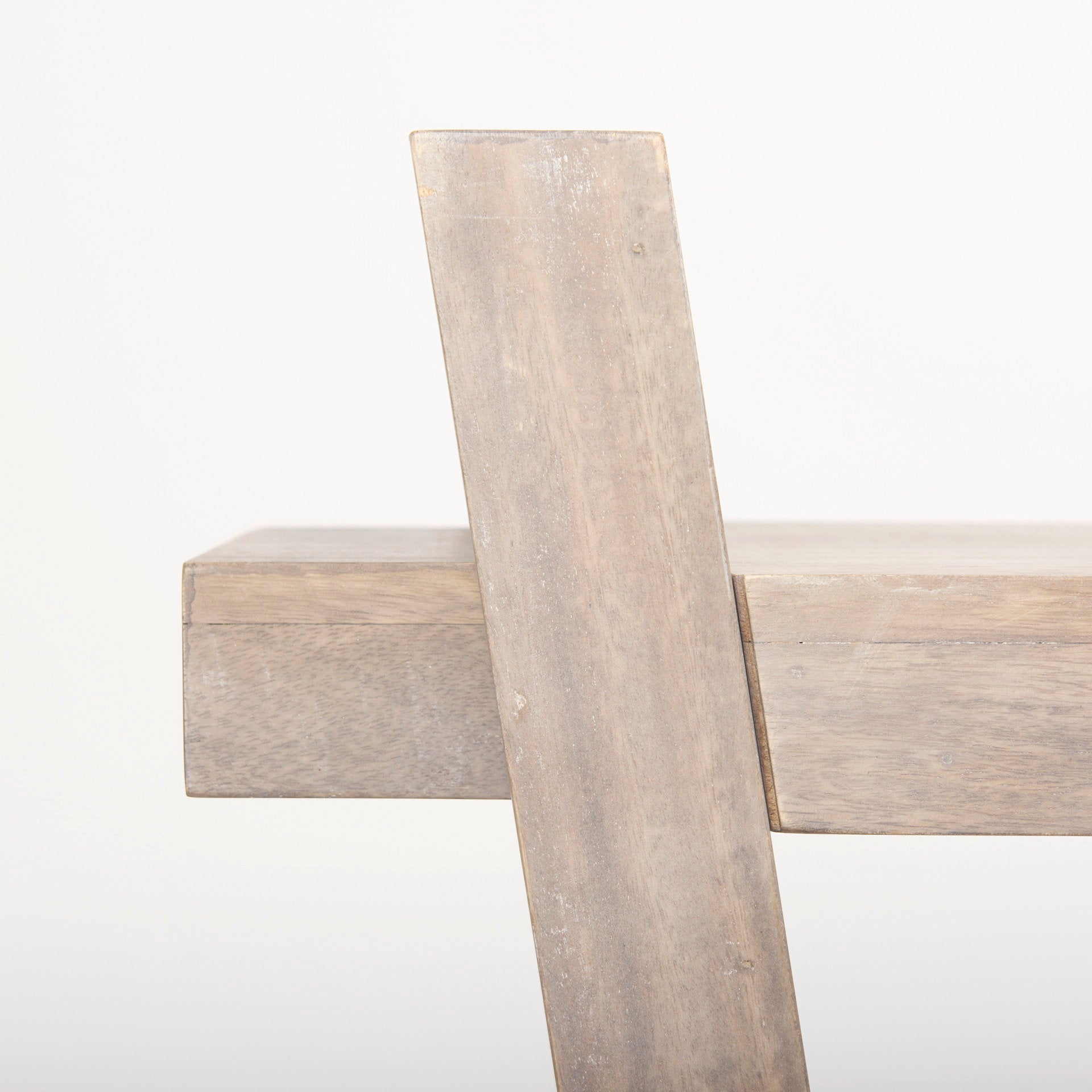 Close-up shot focusing on the high-quality joinery where the angled support leg meets the overhanging tabletop