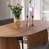 Detailed shot focusing on the solid wood construction and smooth silhouette of the curved pedestal base