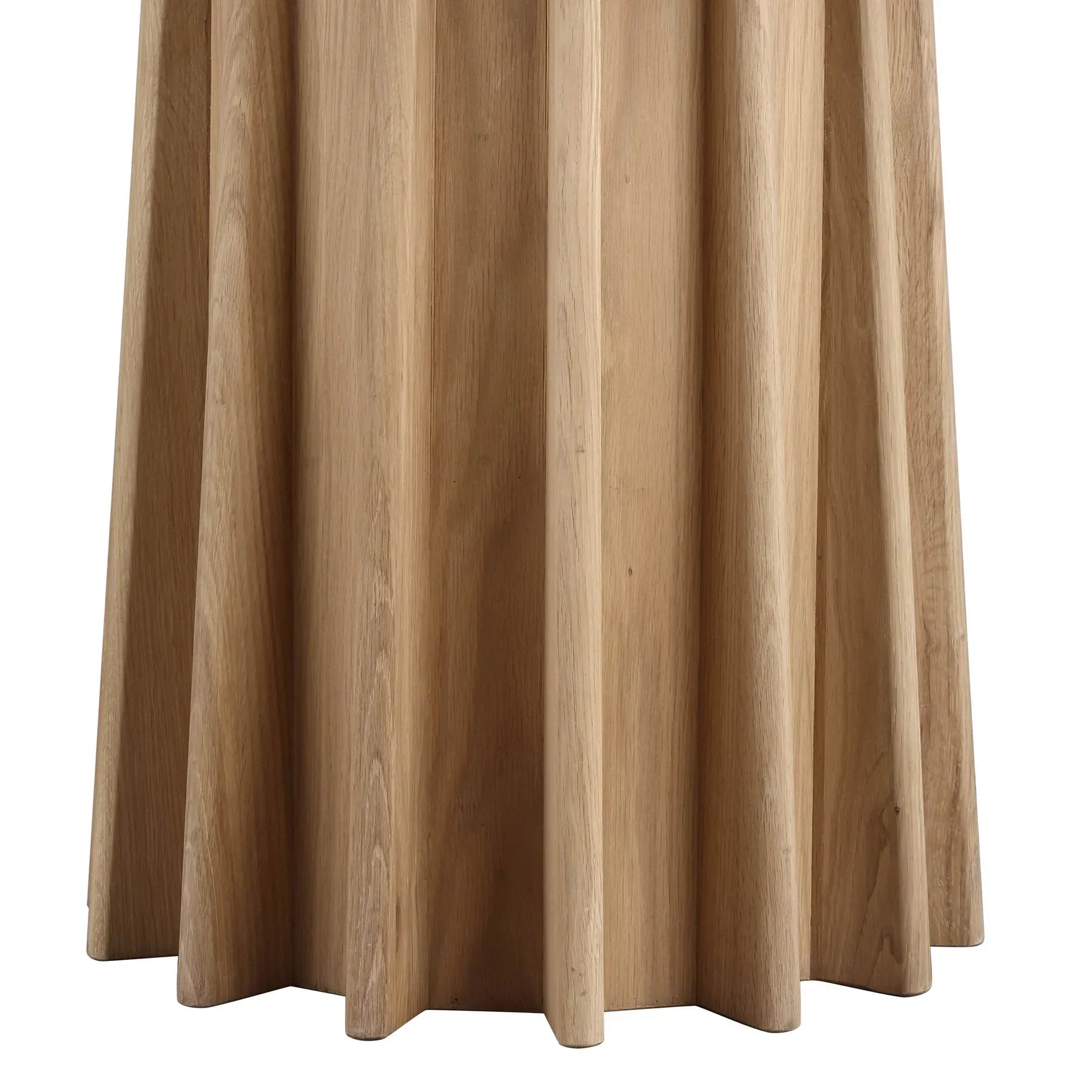 Front view of the Sculpture round dining table featuring a natural oak finish and a striking fluted pedestal base