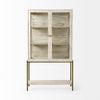 Front view of the Arelius display cabinet featuring white-washed wood, glass double doors, and a slim gold-finished metal base with a lower shelf