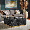 Lifestyle shot featuring the Arreto table in a contemporary living room with a grey sofa and decorative pampas grass
