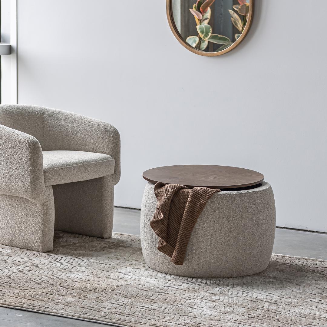 Front view of the Ash round storage ottoman featuring cream bouclé upholstery and a dark wood circular lid 
