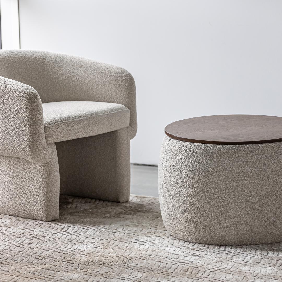 Front view of the Ash round storage ottoman featuring cream bouclé upholstery and a dark wood circular lid 