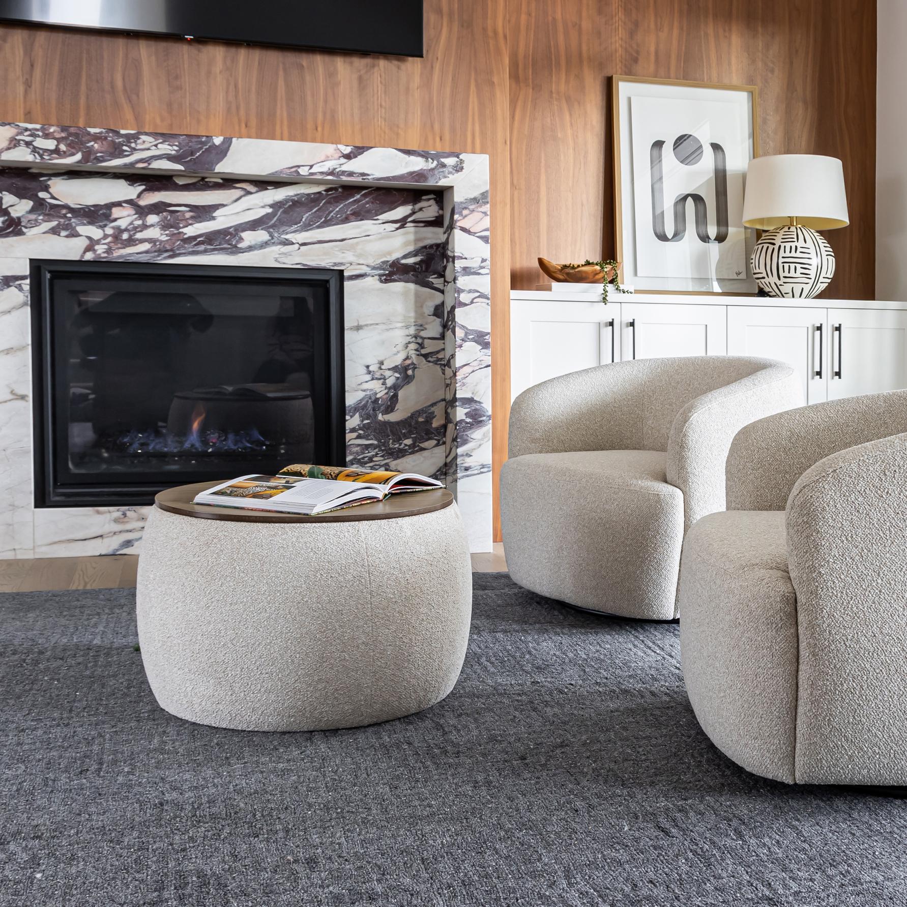 Front view of the Ash round storage ottoman featuring cream bouclé upholstery and a dark wood circular lid 
