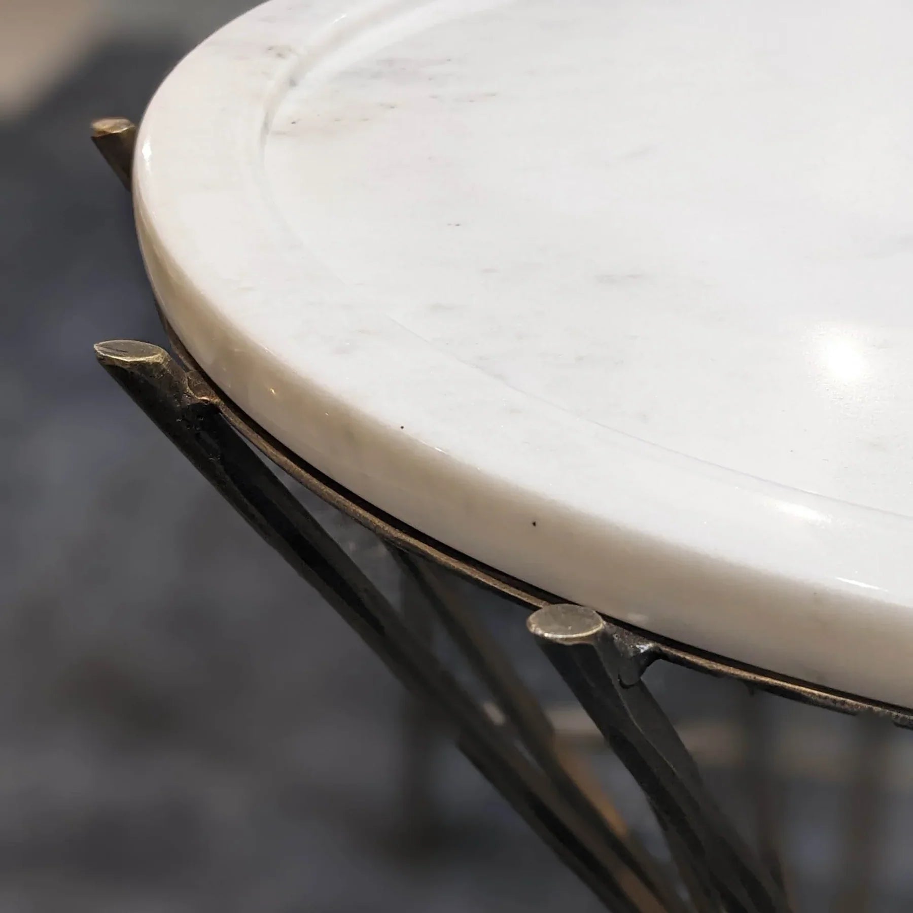 Side view close-up focusing on the thick marble slab and its secure attachment to the gold pedestal frame
