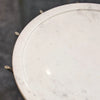 High-angle detail shot showcasing how the gold metal rods support the circular white marble tabletop