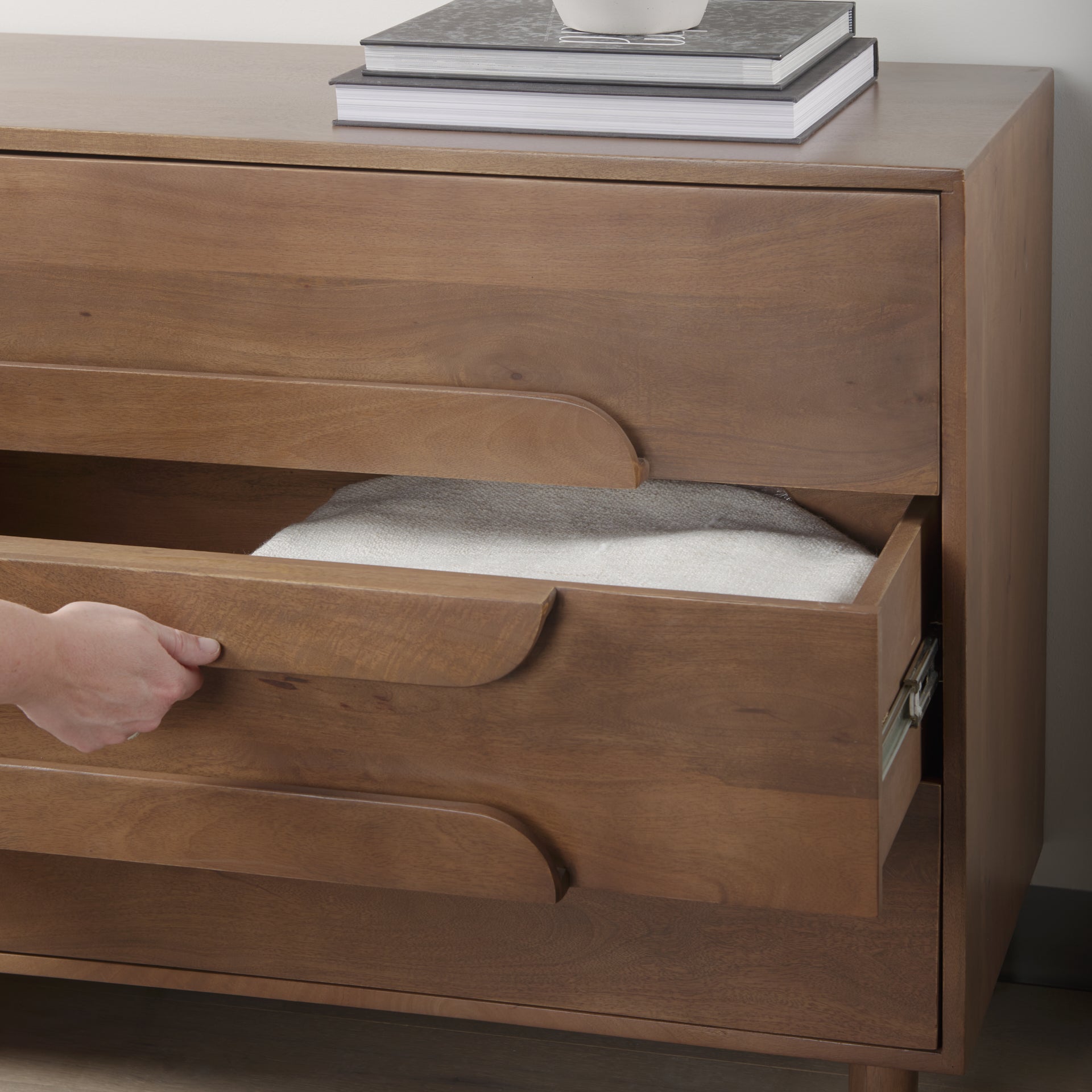 Front view of the Astrid 3-drawer cabinet featuring a warm walnut finish on solid wood with unique integrated oval-shaped drawer pulls