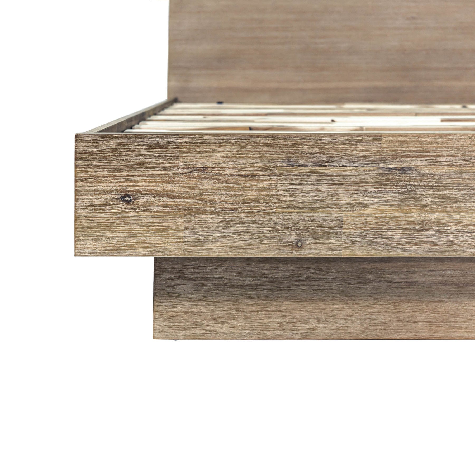 Front view of the Atlantis platform bed featuring a tall headboard with a unique patchwork wood inlay and light driftwood finish