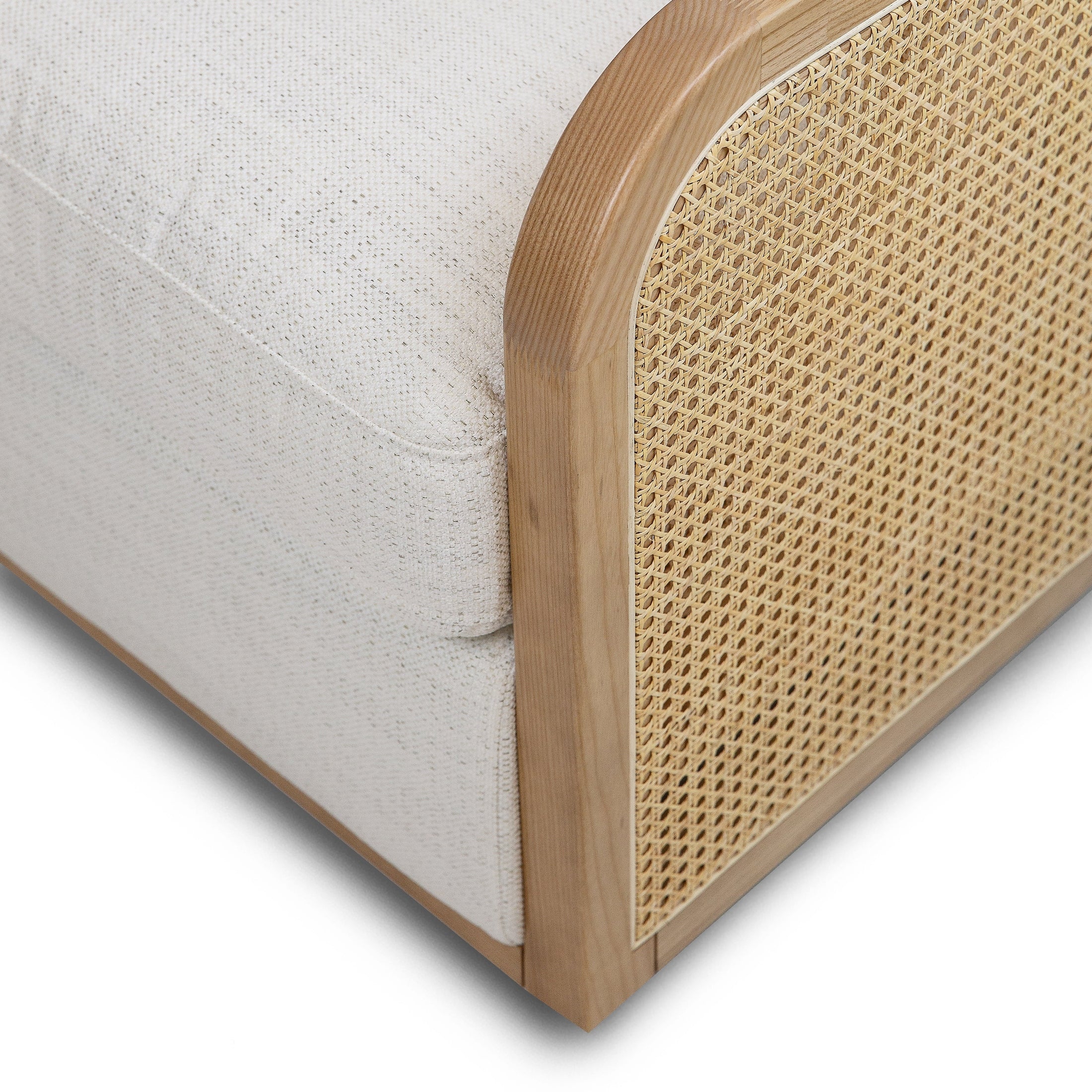 Close-up shot of the smooth, rounded solid oak armrest and the texture of the Prestige Natural fabric.