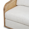 Detailed view of the thick seat cushion and the natural wood frame integration on the Becca accent chair.