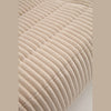 Macro close-up of the beige corduroy vertical channels and high-density foam stitching.