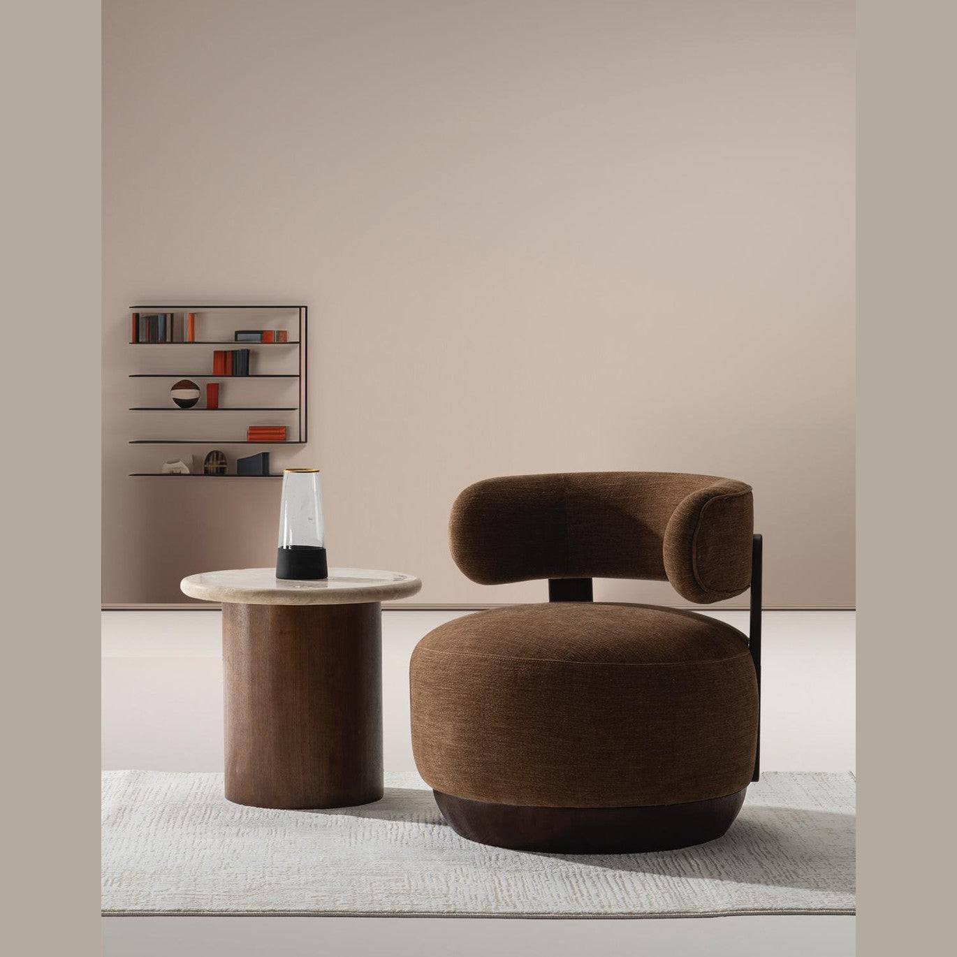 Front view of the Belo Lounge Chair featuring a circular plush seat and a curved wrap-around backrest in coffee brown fabric