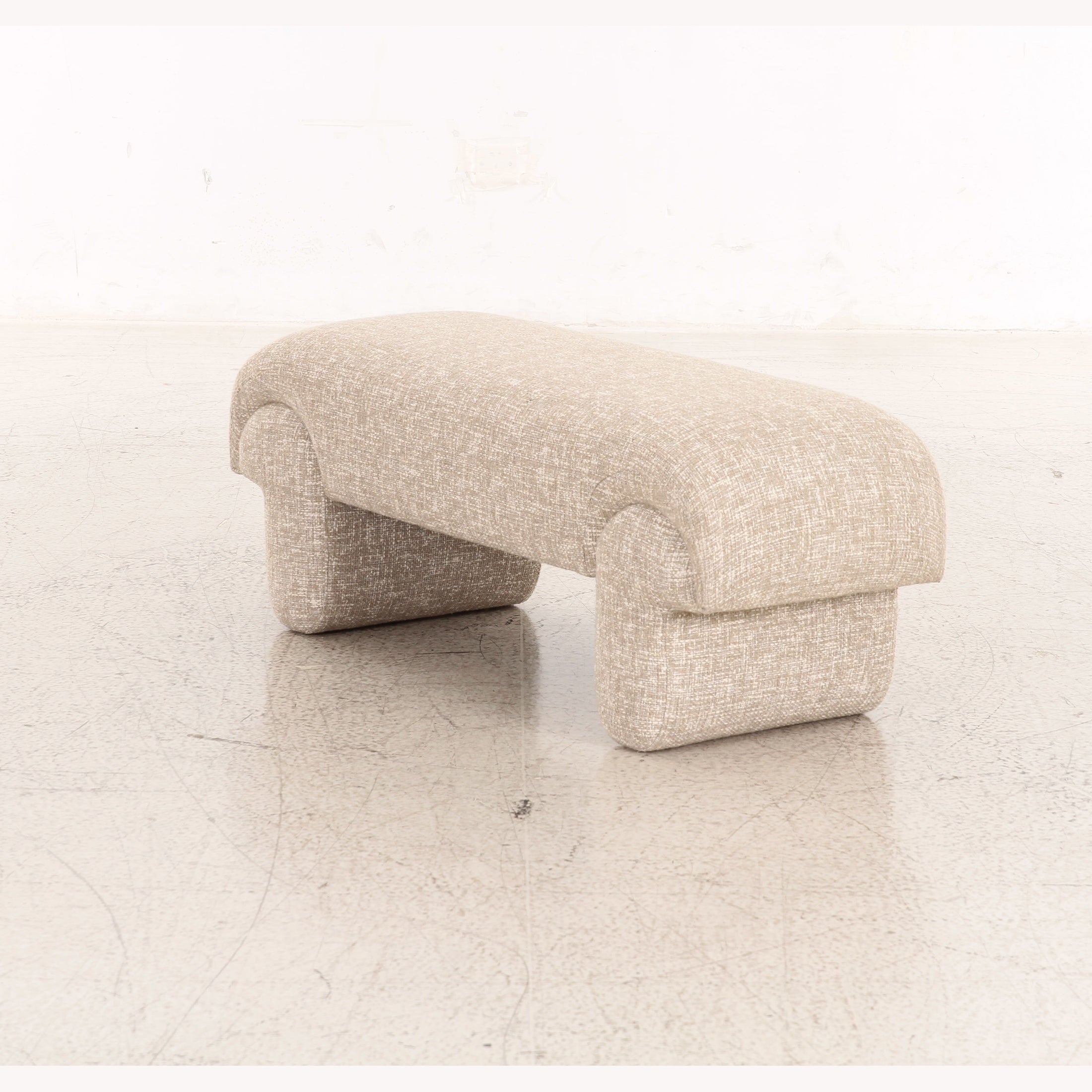 Berger upholstered bench in cream textured fabric with unique sculpted pedestal base