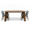 High-angle lifestyle shot showcasing the table styled as a complete set with four grey and black dining chairs
