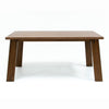 Front view of the Bessa rectangular dining table in a rich walnut finish featuring thick tapered block legs