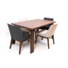 Lifestyle shot featuring the walnut table paired with dark grey chairs on a clean white background