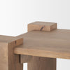 Close-up shot focusing on the natural wood grain and the unique corner construction of the light brown wooden accent table