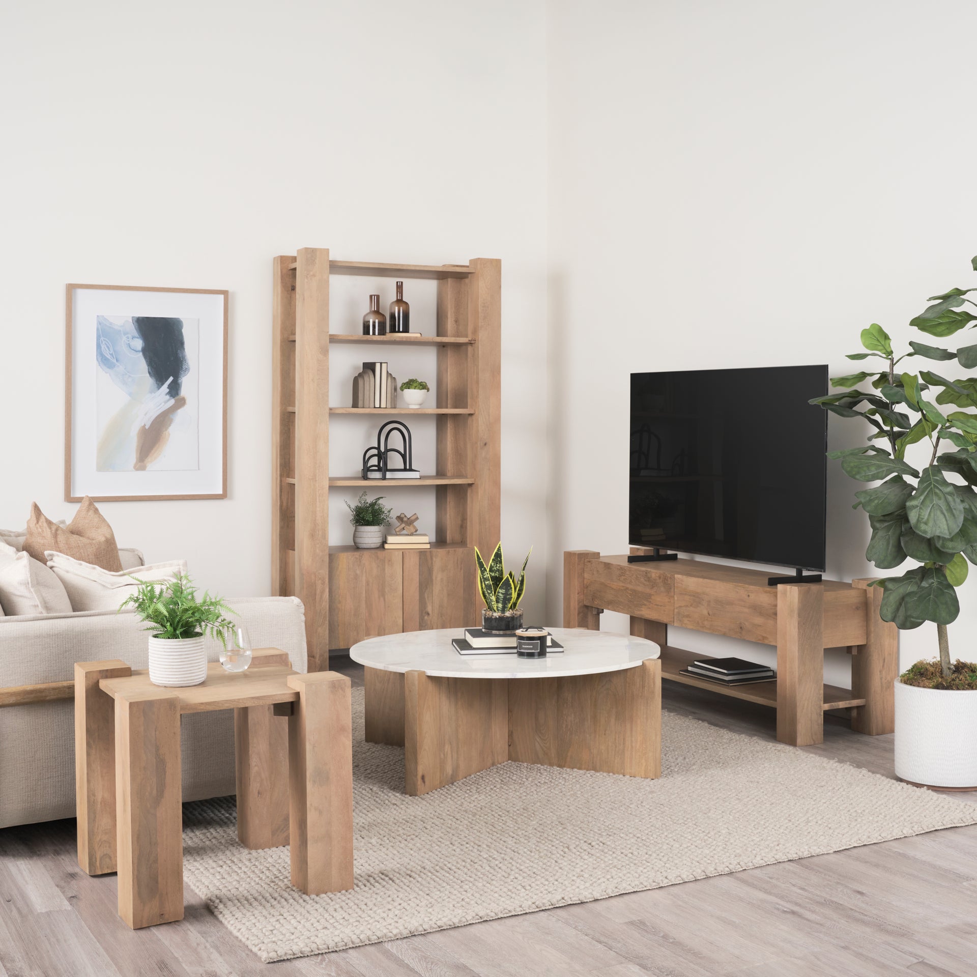 Lifestyle view showing the Beth table integrated into a modern living room set next to a matching wood coffee table and media console