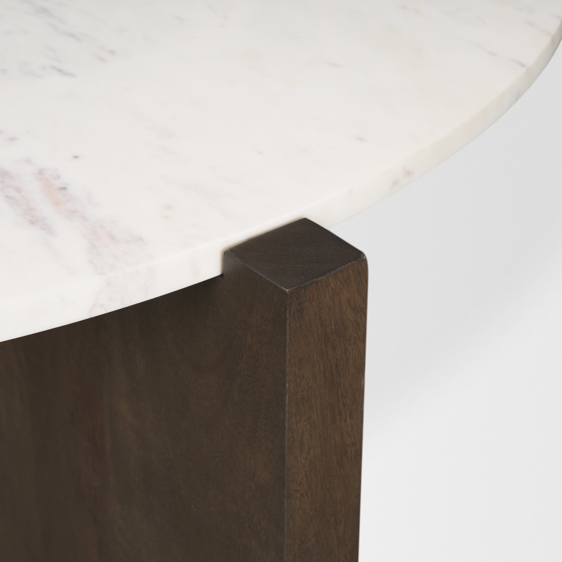 Detailed view of the dark brown wood grain and the square-cut edge of the intersecting slab pedestal base