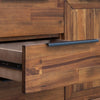 Close-up shot of the minimalist black metal tab handle and the vertical wood plank grain of the drawer front