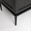 Close-up shot of the tapered black metal legs and the recessed base frame