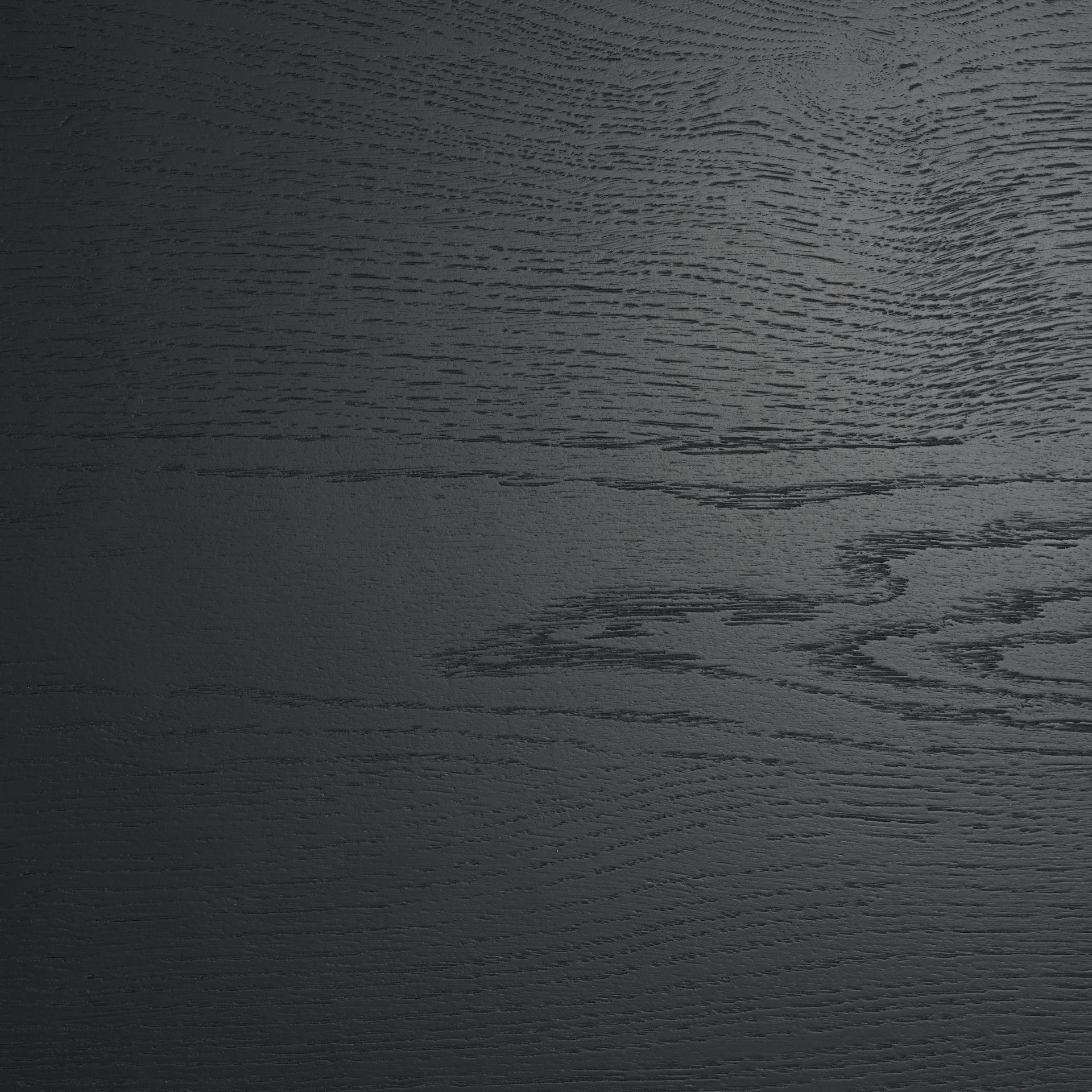 Macro shot focusing on the deep tactile wood grain and matte black finish of the oak door panels