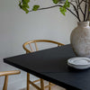 Close-up shot of the table edge and pedestal base intersection emphasizing its clean architectural lines