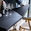 Close-up high-angle view highlighting the subtle wood grain texture and matte black finish of the tabletop