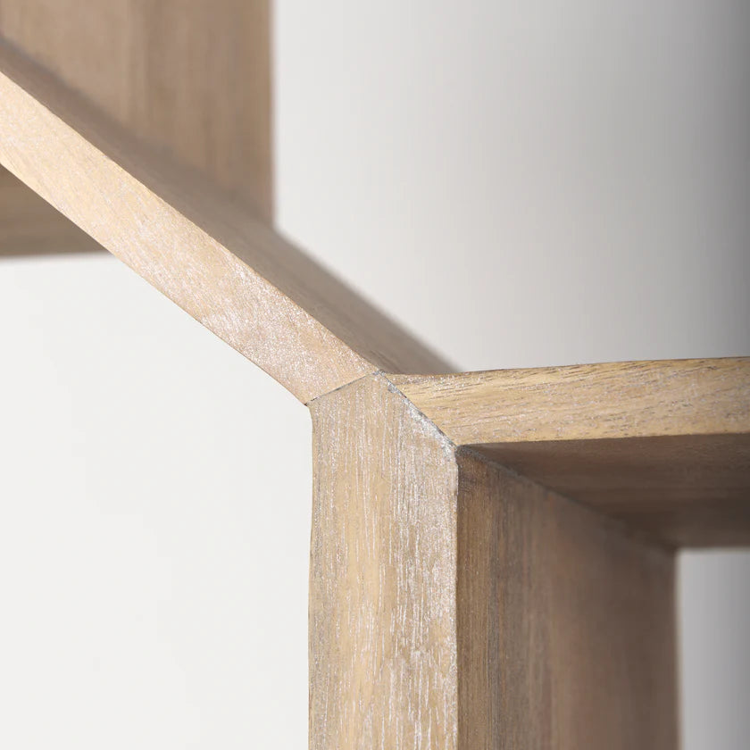 Three-quarter perspective view of the Traro shelving unit in blonde wood featuring a unique geometric honeycomb compartment design