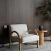 The Bo Accent Chair styled in a dark-walled minimalist room next to a matching oak side table.
