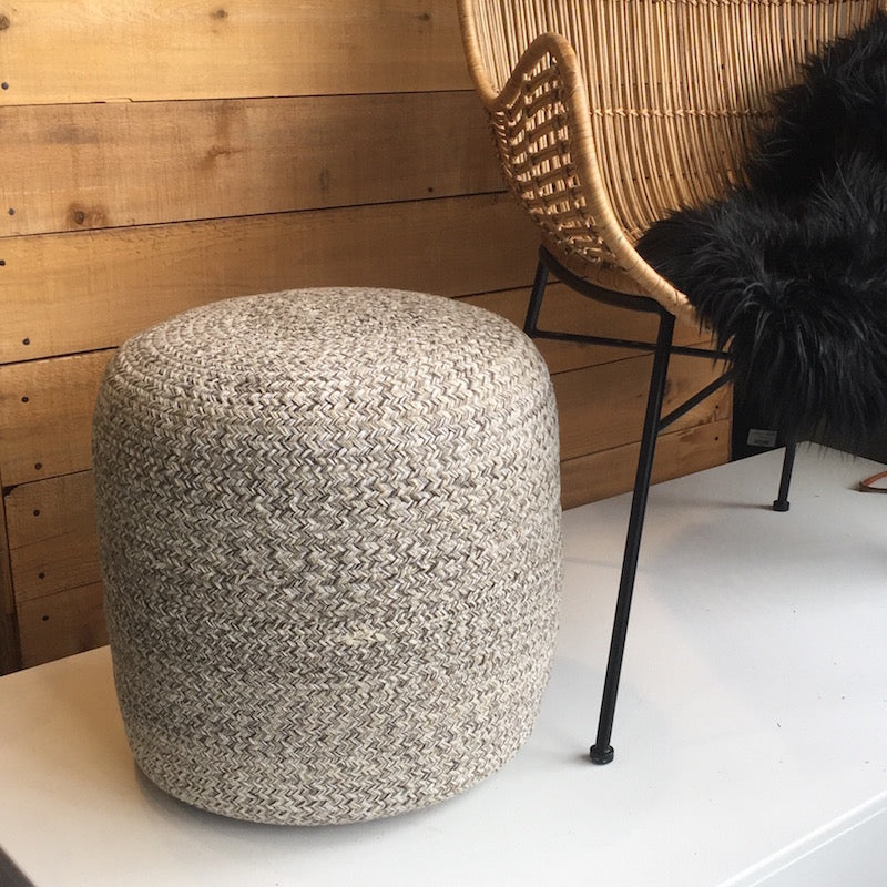 Front view of the Bohemian yarn pouf showcasing a soft braided weave in neutral cream and earth tones