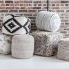 Group shot featuring the Bohemian yarn pouf alongside other textured and patterned decorative ottomans