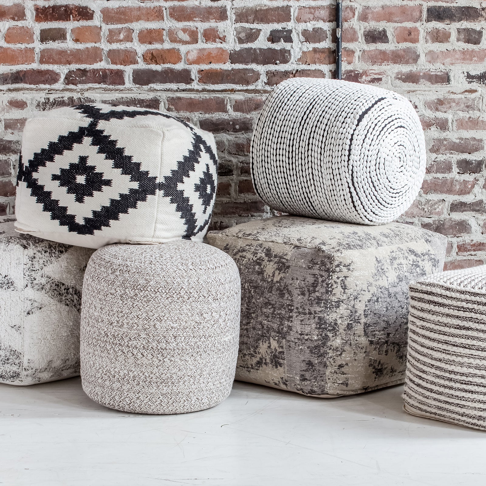 Front view of the Bohemian yarn pouf showcasing a soft braided weave in neutral cream and earth tones