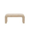 Front view of a minimalist waterfall bench fully upholstered in cream bouclé fabric with a seamless curved silhouette