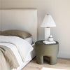 Lifestyle shot showing the bed with the storage lift open while styled with cozy neutral bedding