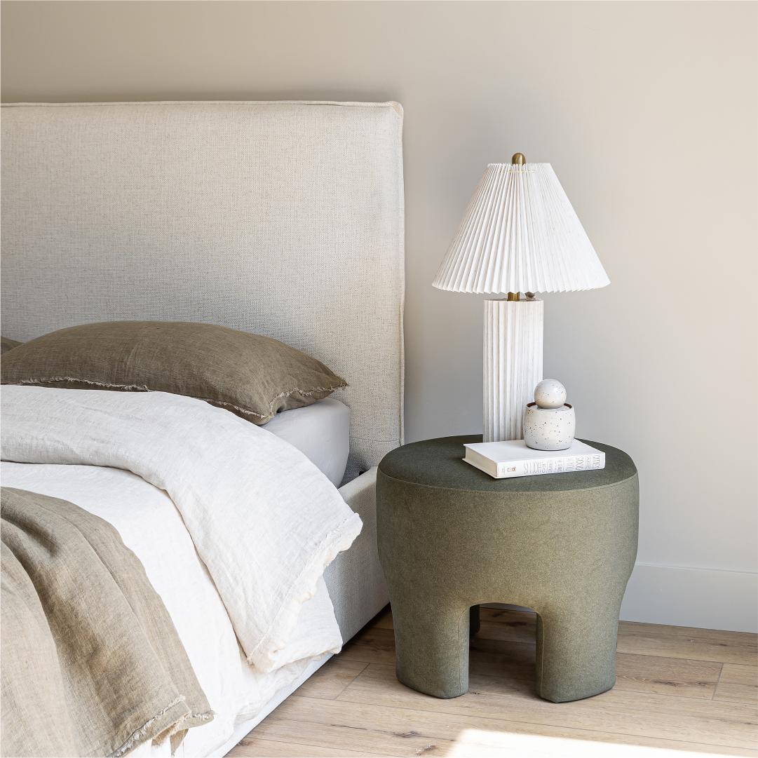 Front view highlighting the soft textured upholstery and the clean architectural lines of the bed frame