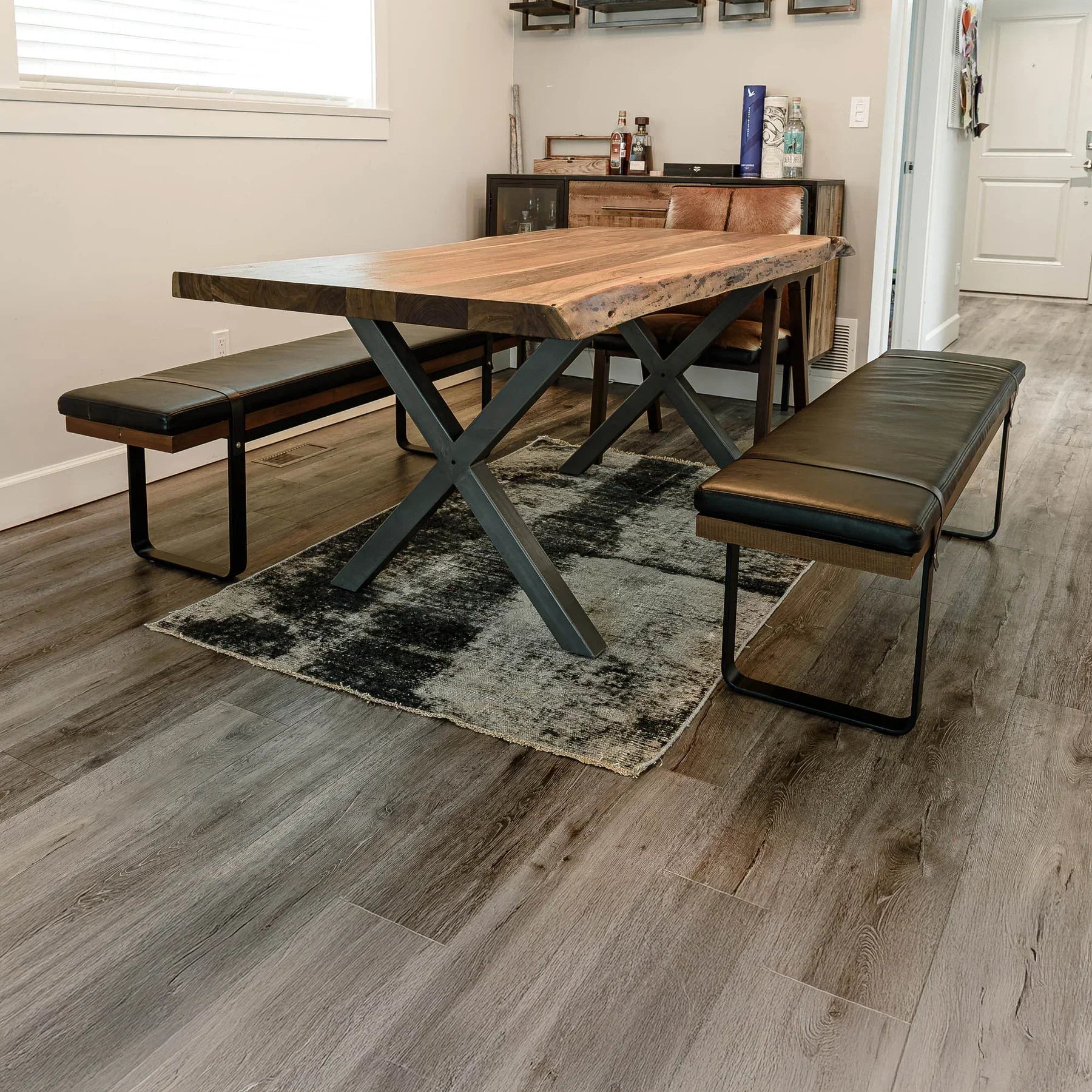 Front view of the Brooklyn upholstered bench featuring a dark leather-style seat, natural wood frame, and black metal sled legs