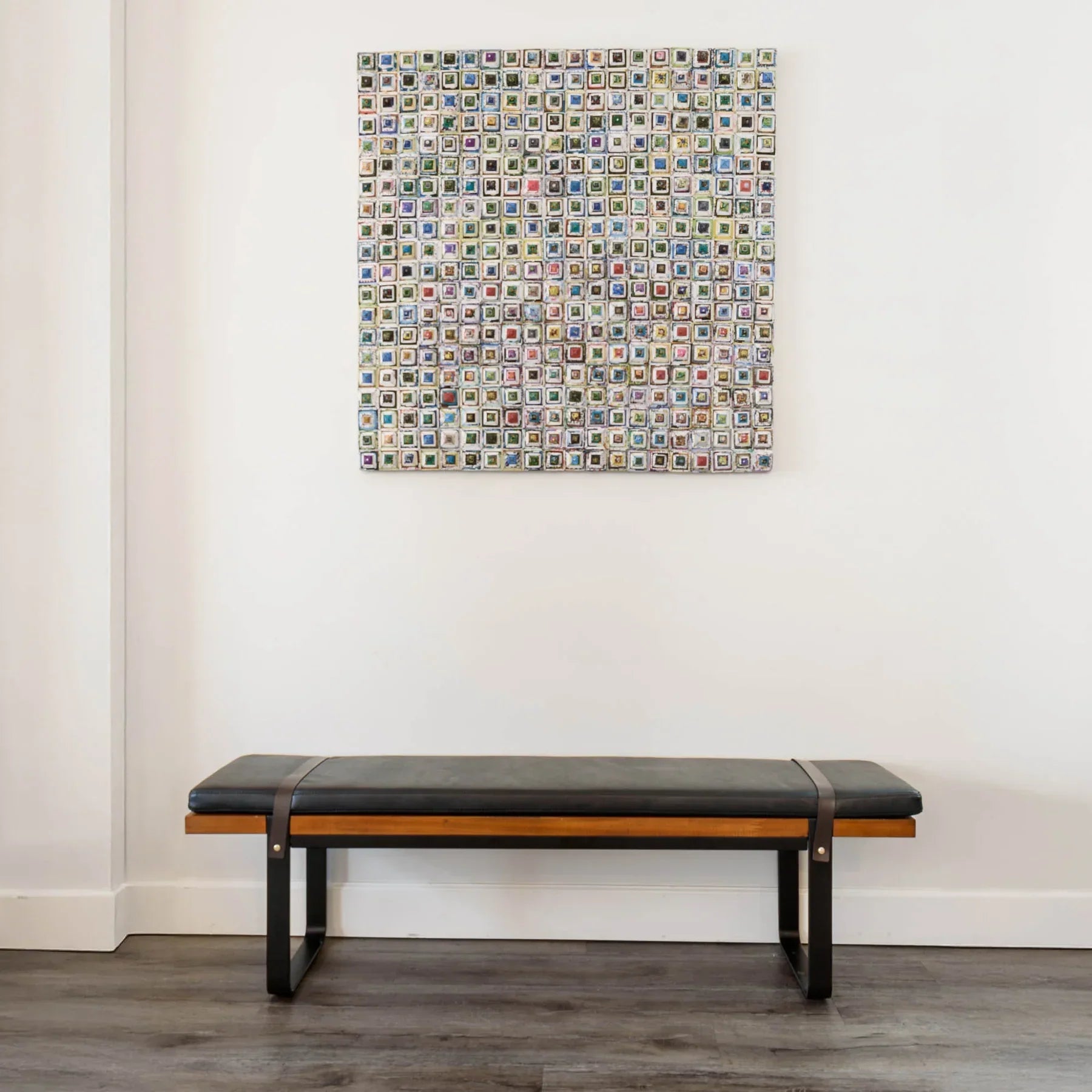 Front view of the Brooklyn upholstered bench featuring a dark leather-style seat, natural wood frame, and black metal sled legs