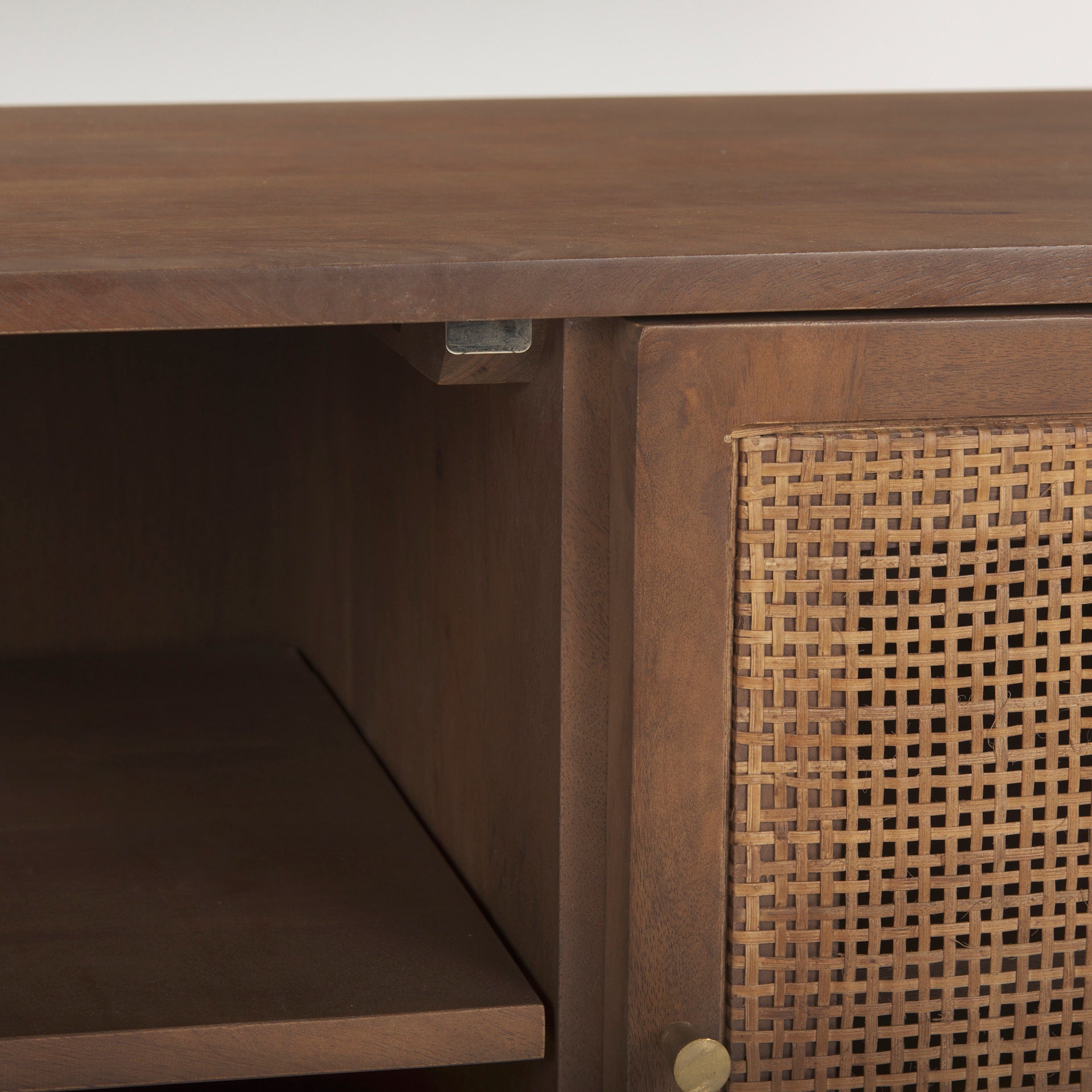 Close-up shot of the integrated cable management port on the brown wood back panel for organized electronics setup