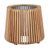 Three-quarter view of the Bungalow side table featuring a round tapered silhouette with vertical natural wood slats and a glass tabletop