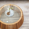 Direct overhead view of the Bungalow coffee table styled with a candle and small plant on the clear glass surface