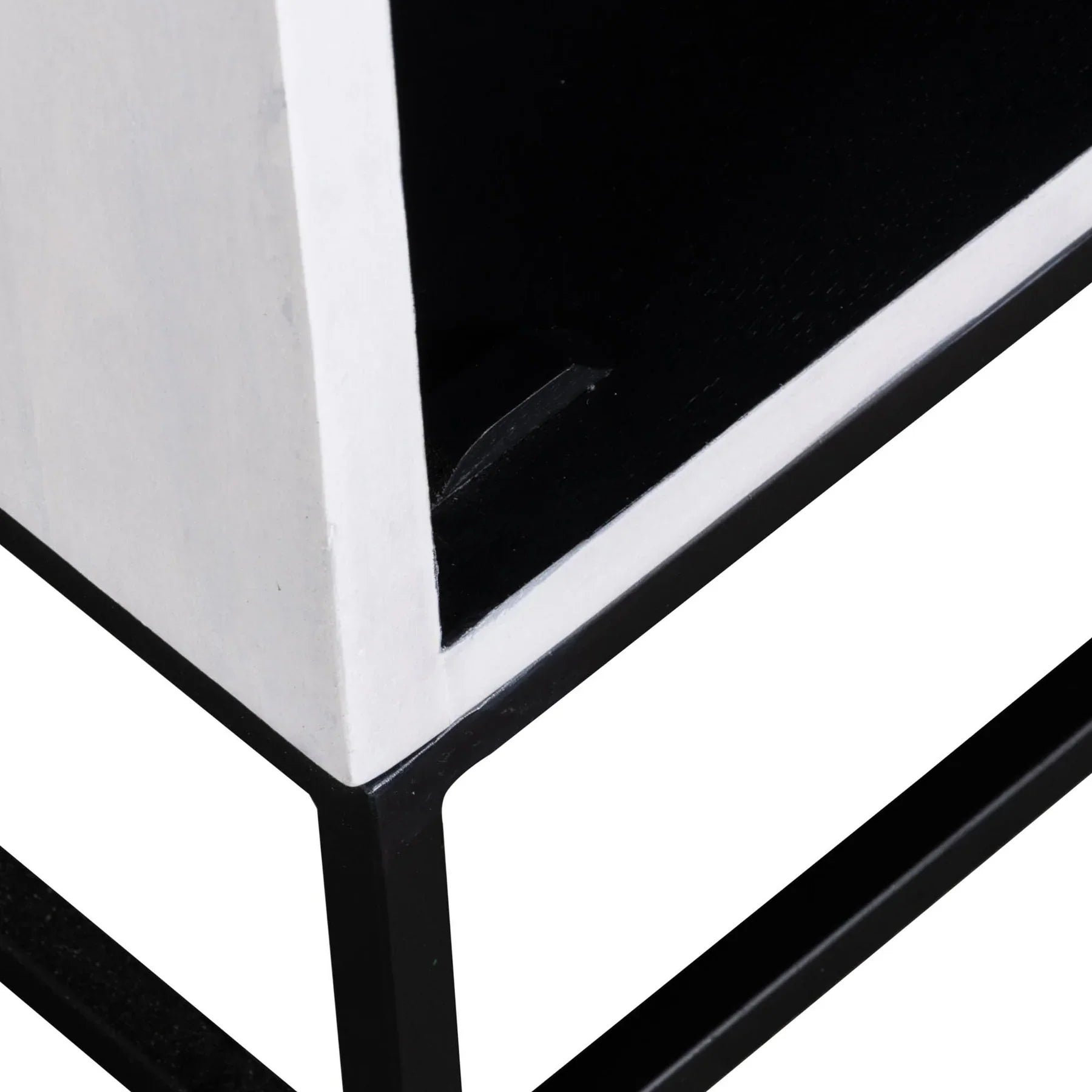 Three-quarter view of the Caged side table featuring a white-finished wooden body with a black-framed glass door and a minimalist metal box base