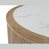 Close-up shot highlighting the smooth edge of the white marble-style top and the vertical texture of the fluted base
