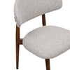 Close-up of Cammy dining chair backrest and seat with beige textured fabric upholstery and walnut wood frame