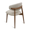 Back angled view of Cammy dining chair with beige textured fabric upholstery and curved walnut wood frame and legs