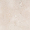 Macro detail view of the cream travertine tabletop showcasing its organic stone texture and subtle natural variations