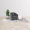 Lifestyle shot of the charcoal Carmen chair in a bright studio setting with a white side table